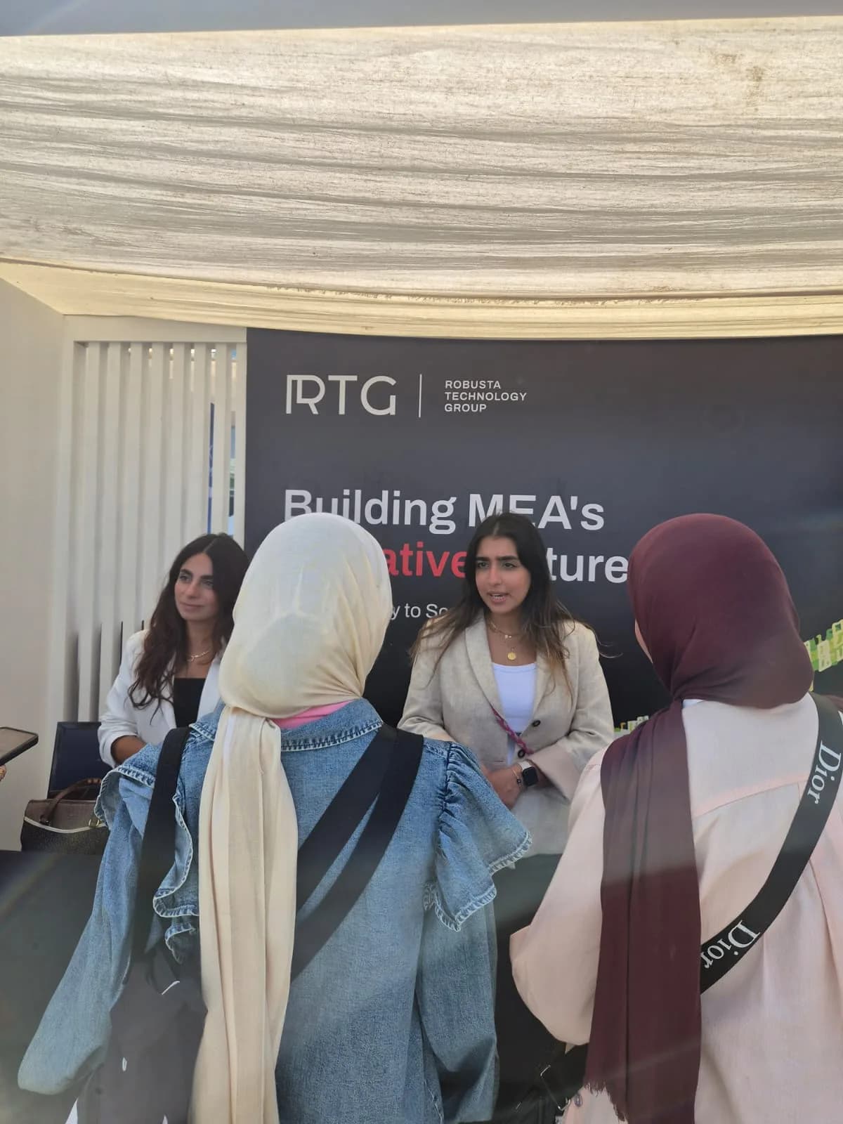 The RTG team speaking with visitors at the booth